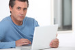 © auremar - Man using a laptop computer