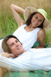 © auremar - 40 years old man and woman relaxing and  lying down in a meadow
