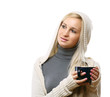 © lenets_tan - A young woman with a hood on head is drinking