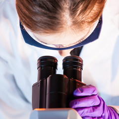 Poster - Researcher microscoping.