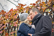 © ChaosMaker - Date. Young woman and man kisses outdoor. Autumn