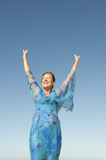 Fototapeta  - Portrait joyful mature woman isolated sky
