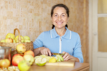 Wall Mural -  woman cooks applesauce jam