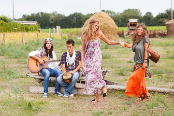 Wall Mural - Hippie Group Playing Music and Dancing Outside