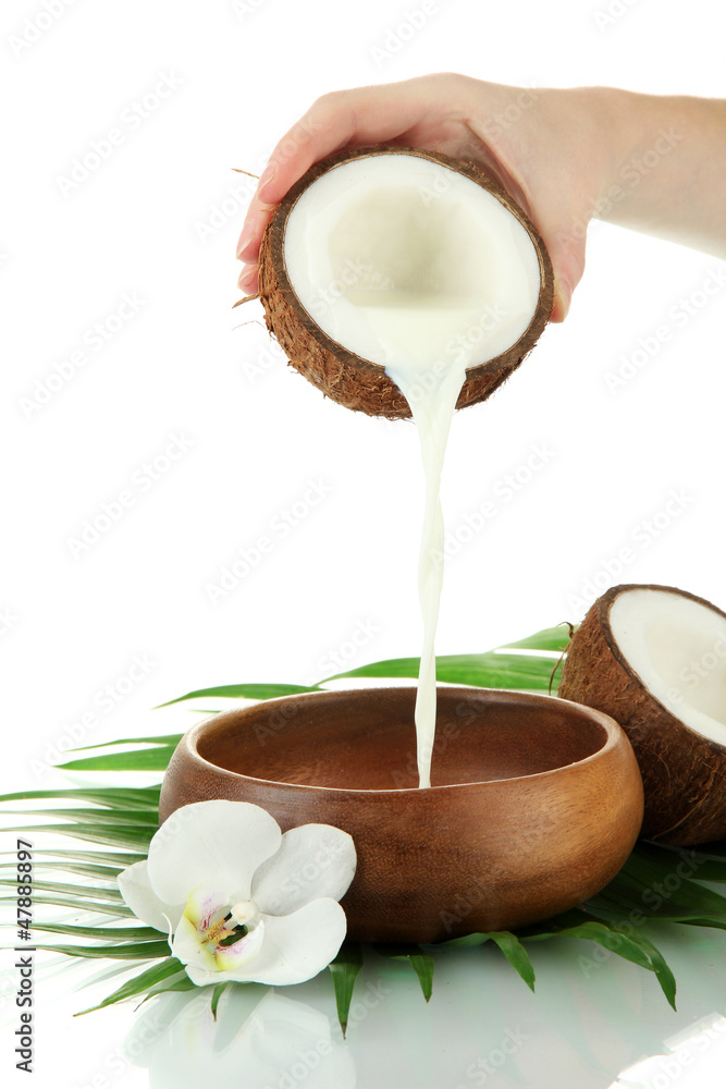 Coconut with coconut milk and leaves, isolated on white