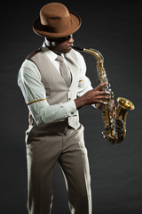 Black american jazz saxophone player. Vintage. Studio shot.