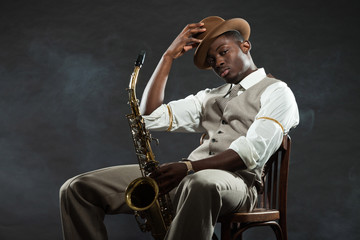 Black american jazz saxophone player. Vintage. Studio shot.