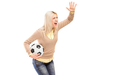 Poster - A female sport fan holding a football and shouting