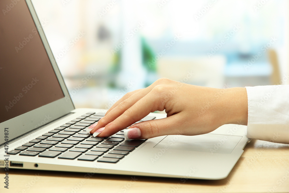 female hand writing on  laptot, close up