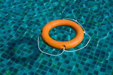 Wall Mural - Orange Safety Lifebelt in Swimming Pool closeup