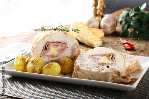 Fotografie, Obraz Roulade of stuffed chicken with potatoes and rosemary