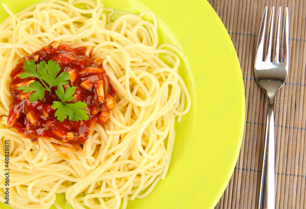 Italian spaghetti in plate on bamboo mat