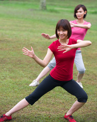 Wall Mural - asian girls tai chi.outdoor , chinese women