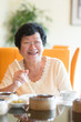 © WONG SZE FEI - Senior Asian Woman dining