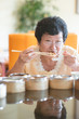 © WONG SZE FEI - Senior Asian Woman dining at restaurant