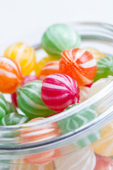 Wall Mural - colorful round candies in a glass vessel