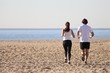 © Antonioguillem - Man and woman running in the beach