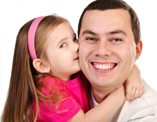 Wall Mural - Little girl kissing her smiling father isolated