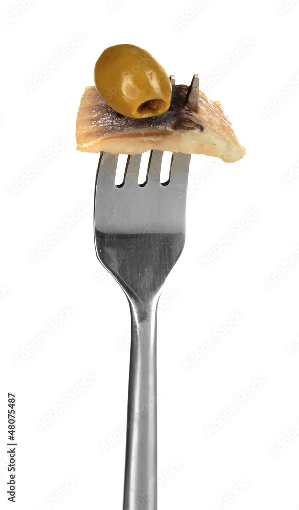 Piece of herring and olive on fork isolated on white