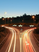 Car Light Trails On The Road And Paper Boats In A Roundabout