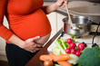 © Martinan - Pregnant woman cooking broccoli