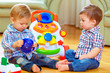 © Olesia Bilkei - funny baby toddlers playing toys at home