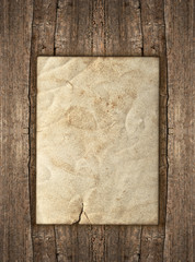 Wall Mural - old paper sheet over rustic wooden background