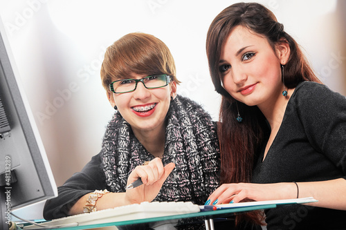 Two Schoolgirls Doing Homework Kaufen Sie Dieses Foto Und Finden Sie 
