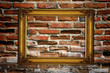 Gold frame on old red brick wall