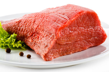 Raw beef and vegetables on white background