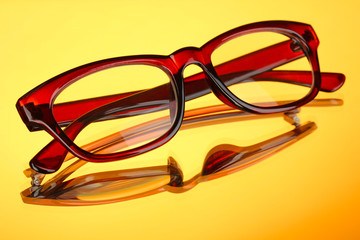 Poster - Beautiful glasses on yellow background