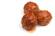 portion roasted meatballs under meat sauce