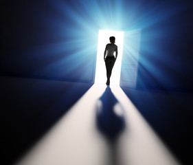 Wall Mural - woman walking into light