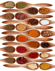 Wall Mural - Concept with spices on wooden spoons on white background