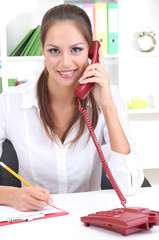 Wall Mural - Young pretty business woman with phone writing at office