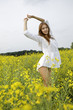 © bartekwardziak - brunette woman in a yellow flowers field
