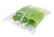 A sealed plastic bag of lettuce on a white background
