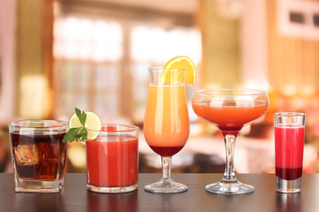 Wall Mural - Several glasses of different drinks on bright background