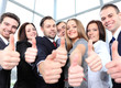 © opolja - Successful young business people showing thumbs up sign