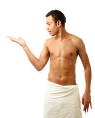 A nude young man covering himself with a towel