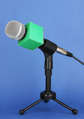 Microphone on stand on blue background