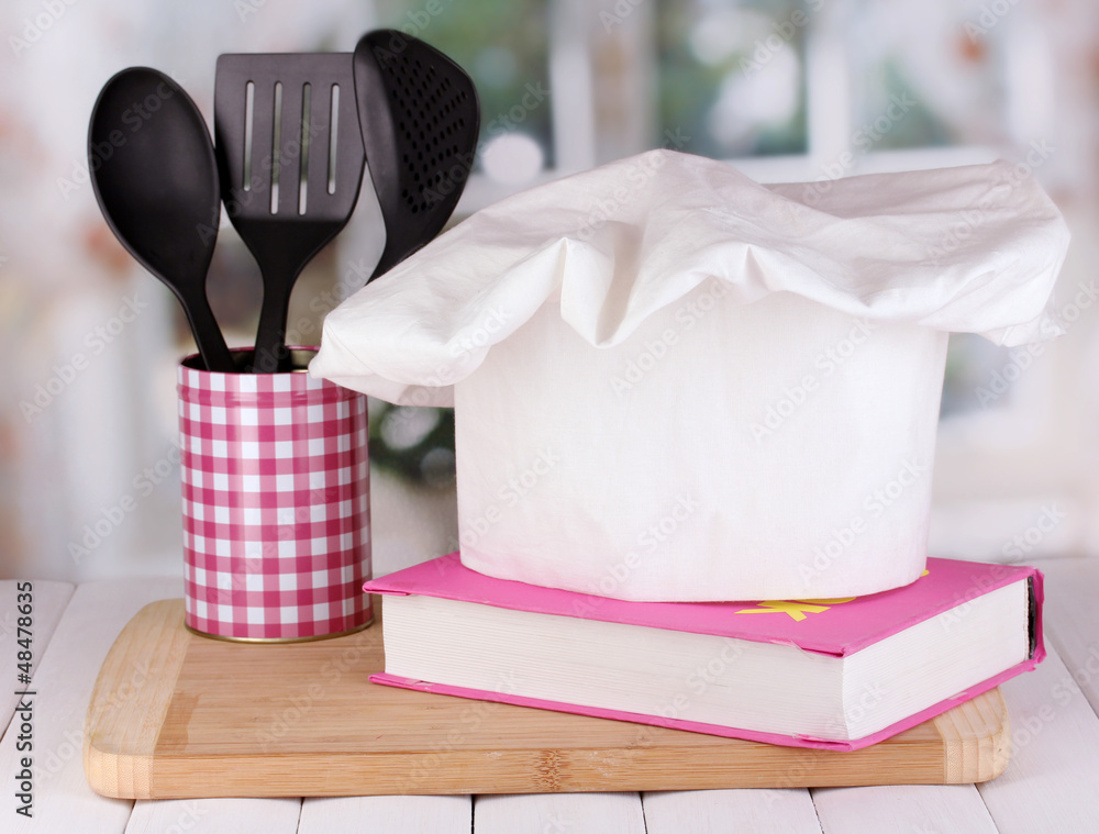 Chef's hat with spoons and cook book