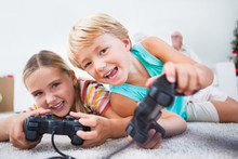 Siblings Having Fun Playing Video Games