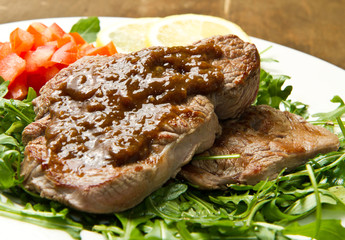 meat table : roast beef fillet with vegetables served on white p