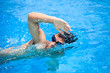 © lightpoet - Young man swimming the front crawl in a pool
