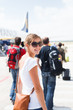 © lightpoet - Departure - young woman at an airport about to board an aircraft