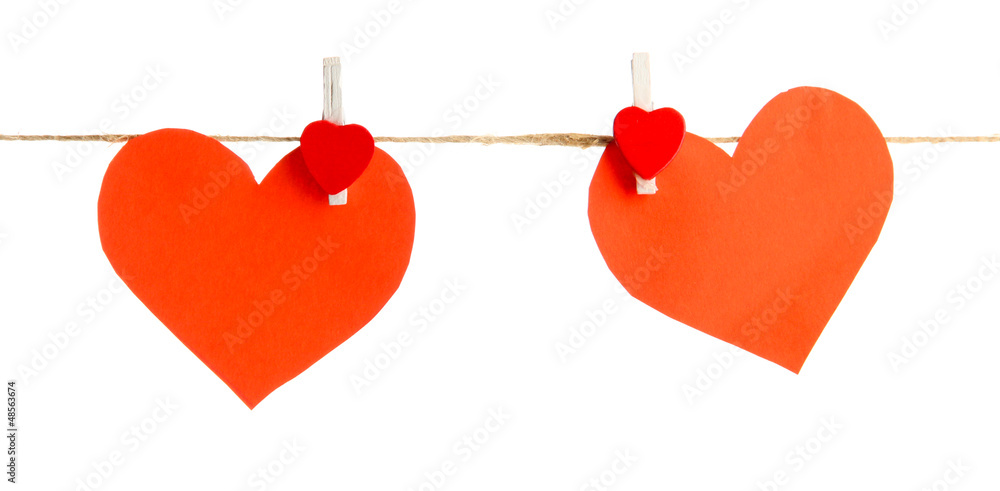 two paper hearts on rope, isolated on white