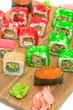 © evgenyi - sushi with red caviar and rolls on a cutting board