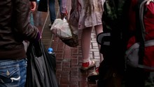 Girl In Bloody Dress Walks By Pavement With Basket