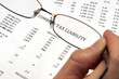 Hand magnifying glasses  tax liability on financial paper